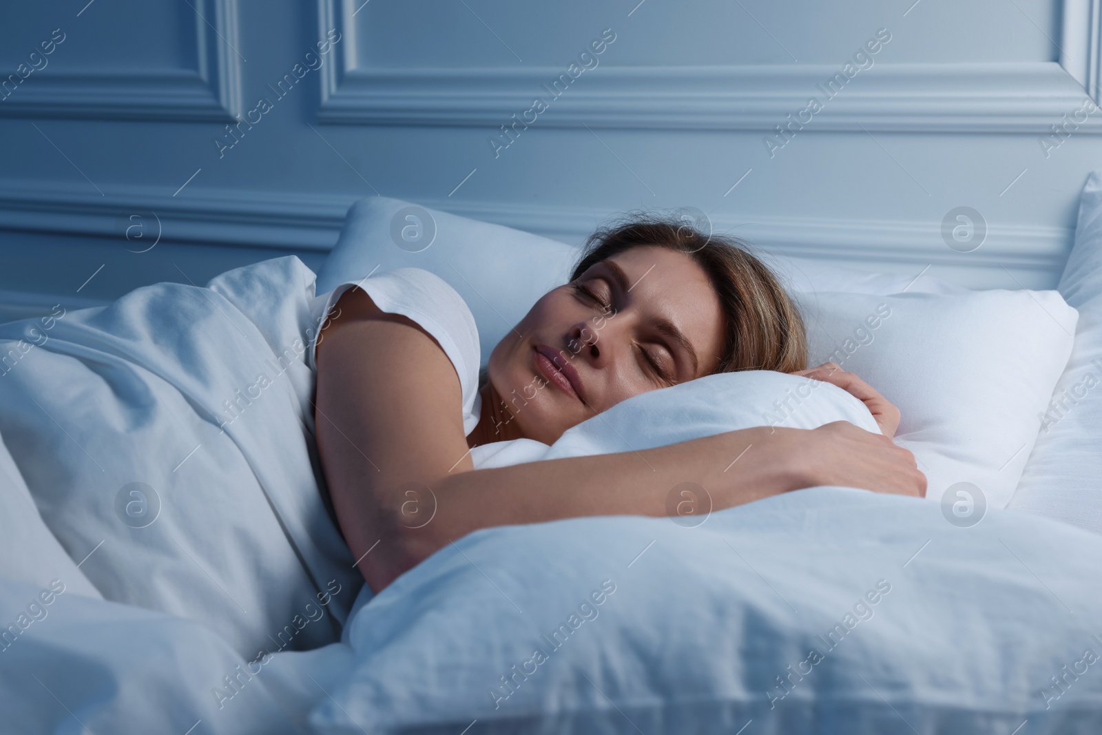 Photo of Beautiful woman sleeping in bed at night