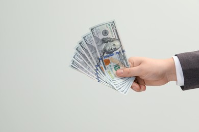 Photo of Man holding money on white background, closeup. Currency exchange