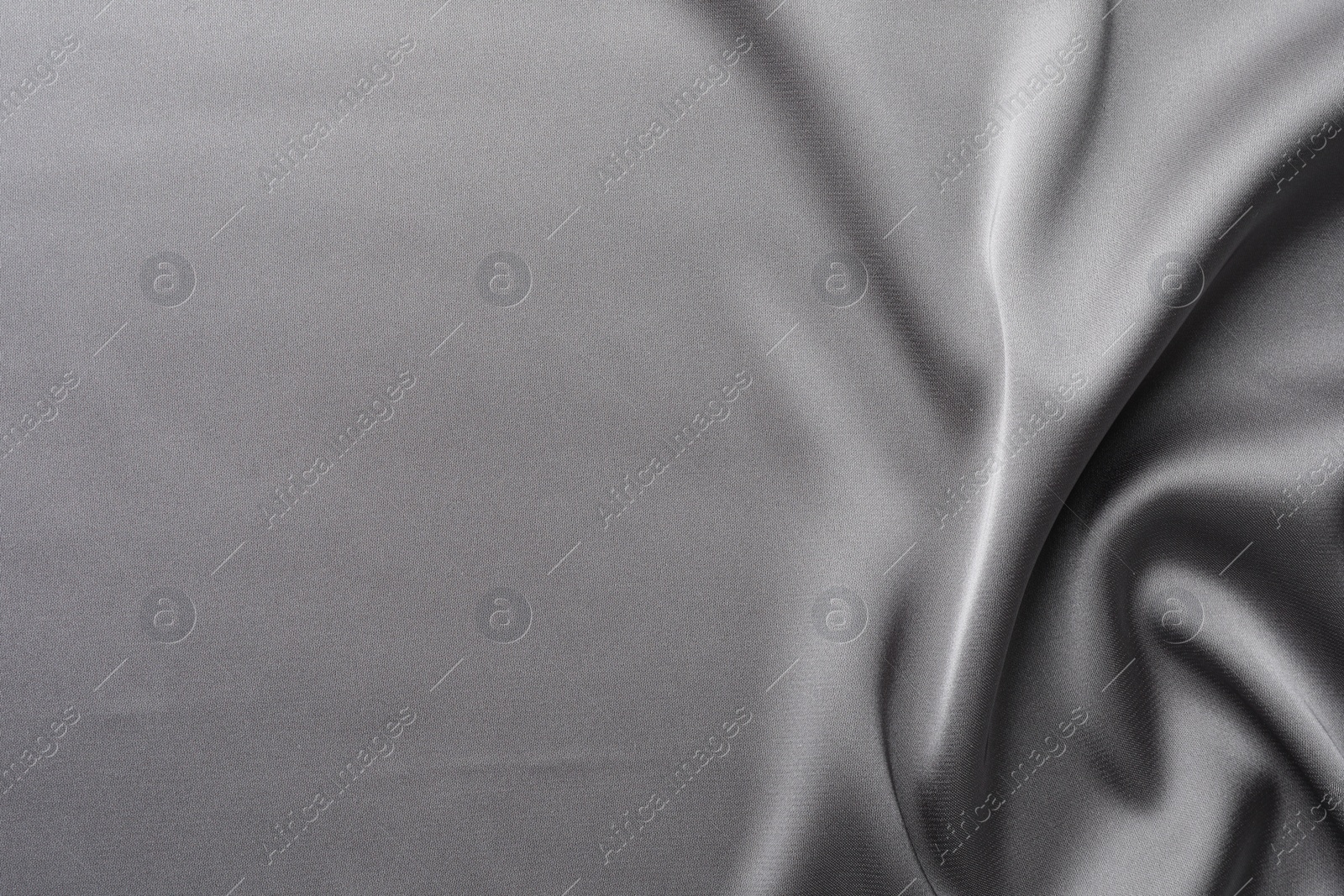 Photo of Texture of beautiful light grey silk fabric as background, closeup