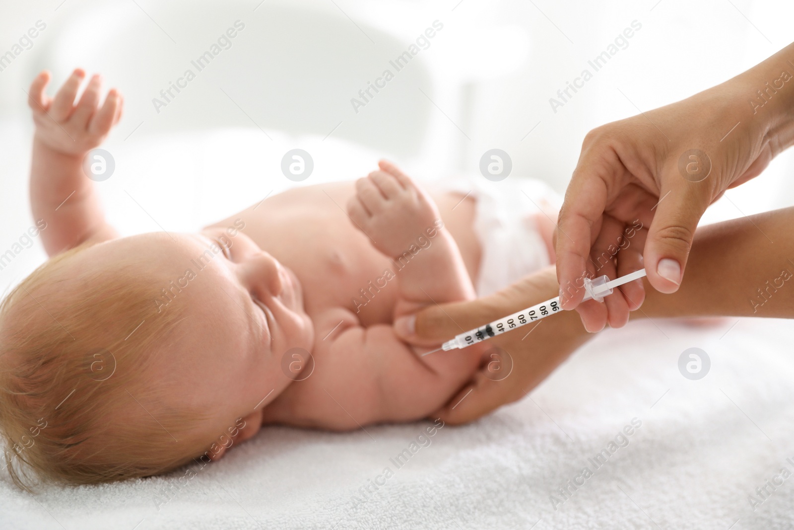Photo of Doctor vaccinating cute baby, closeup. Health care