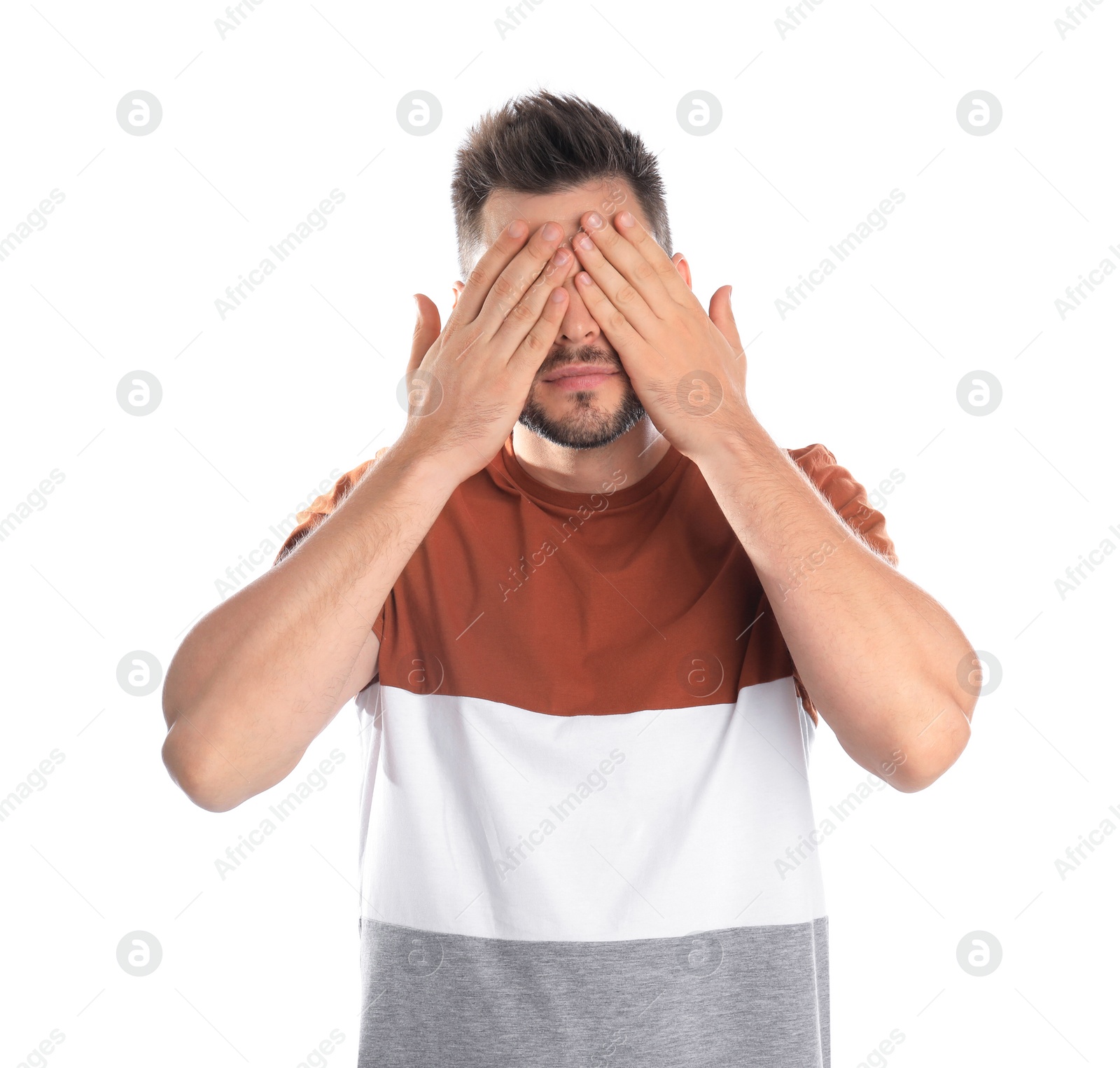 Photo of Man covering eyes while being blinded on white background