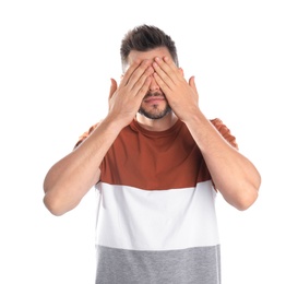 Photo of Man covering eyes while being blinded on white background