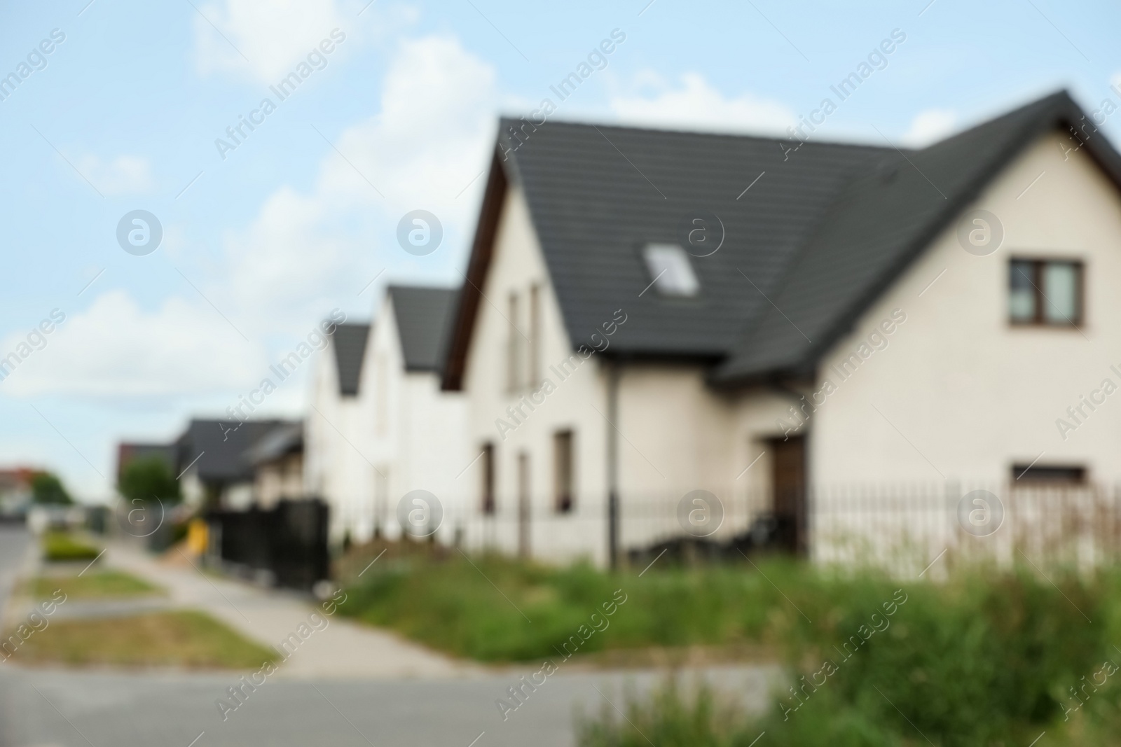 Photo of Blurred view of street with beautiful houses