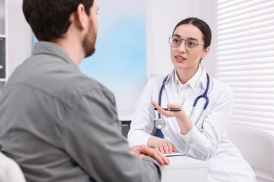 Doctor consulting patient during appointment in clinic