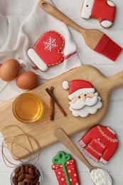 Delicious Christmas cookies and ingredients on white wooden table, flat lay
