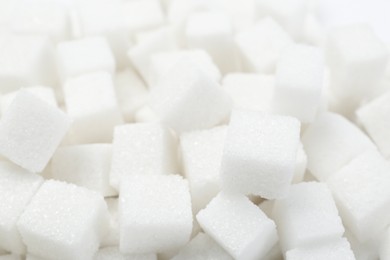 Photo of Many refined white sugar cubes, closeup view