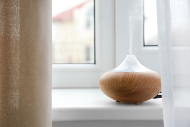 Photo of Aroma oil diffuser on window sill