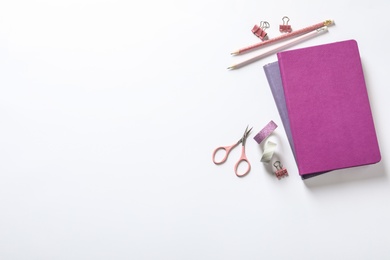 Composition with scissors and stationery on white background, top view