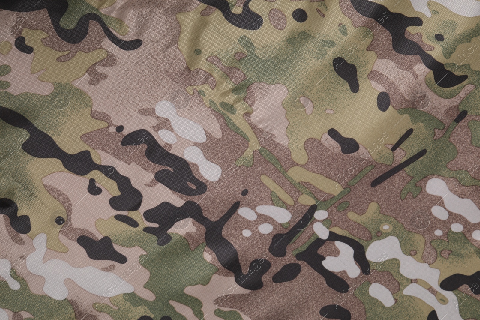 Photo of Texture of camouflage fabric as background, top view