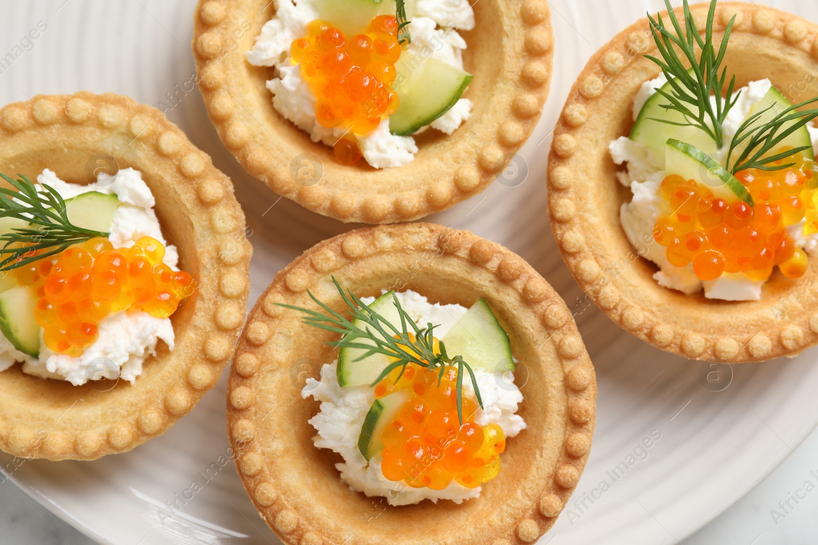 Photo of Delicious canapes with red caviar on table, top view