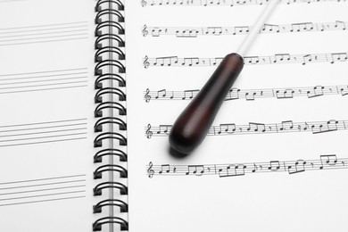 Photo of Conductor's baton on sheet music book, closeup