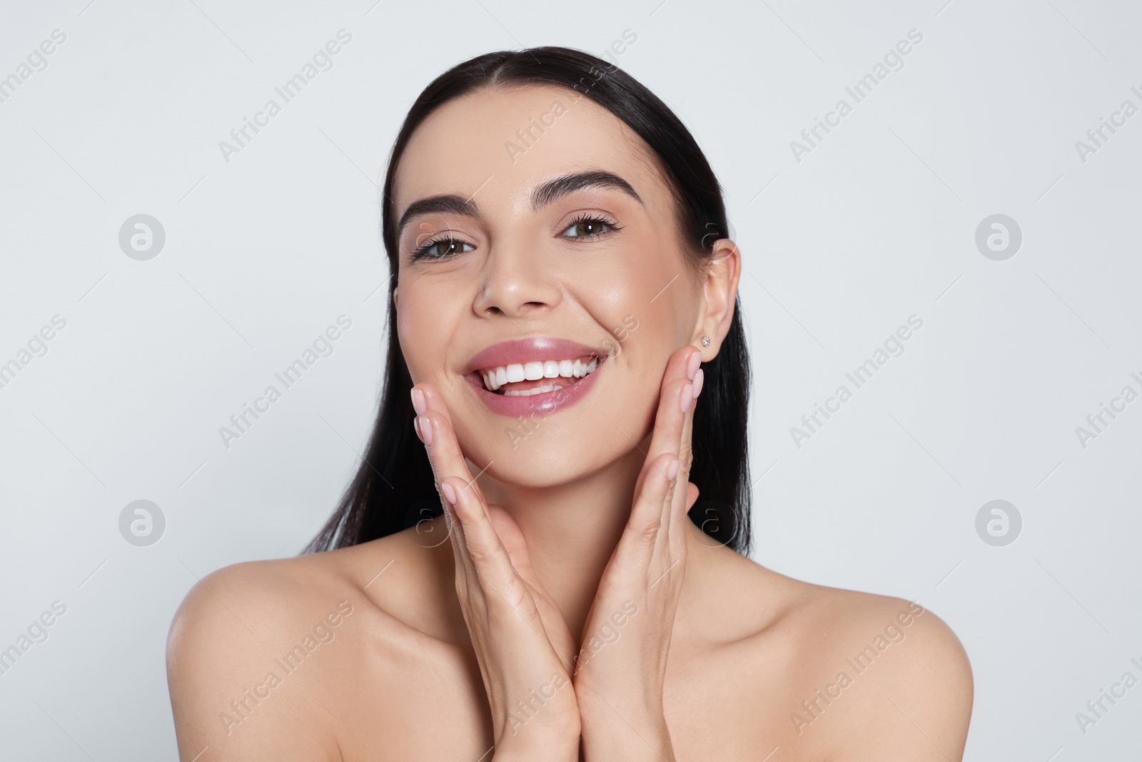 Photo of Portrait of attractive young woman on light grey background. Spa treatment