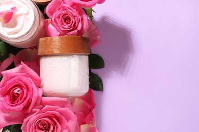 Photo of Flat lay composition with jars of face cream and beautiful flowers on violet background. Space for text