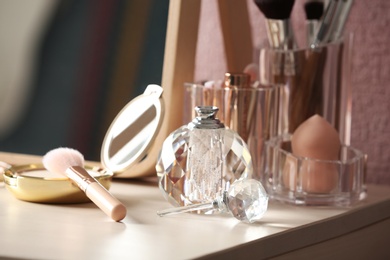 Pocket powder with brush and perfume bottle on dressing table