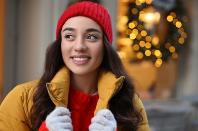 Portrait of smiling woman on city street in winter