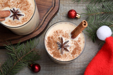 Photo of Flat lay composition with delicious Christmas liqueur on wooden table