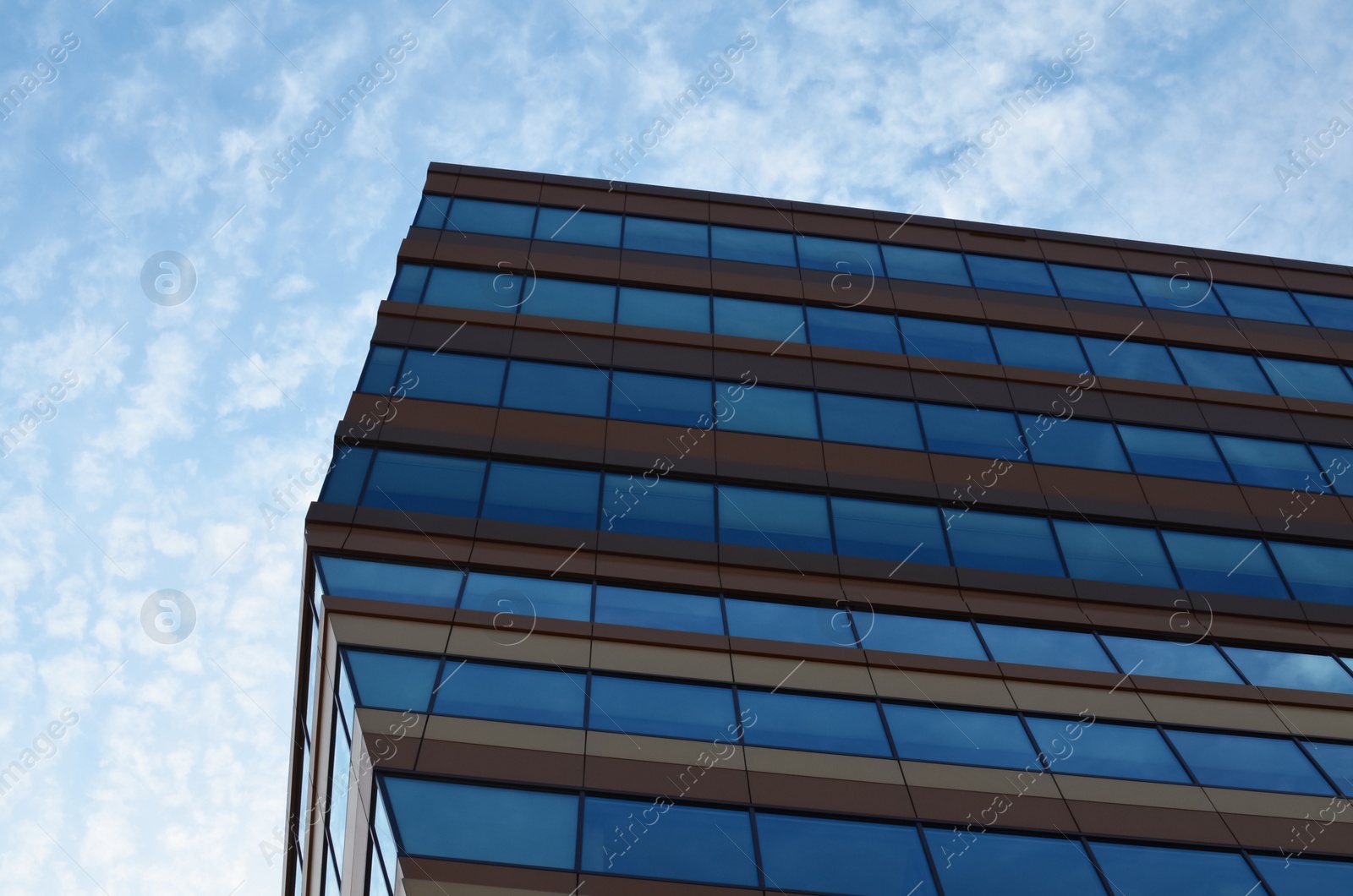 Photo of Modern building against blue sky, low angle view