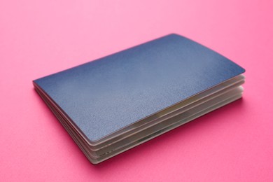 Photo of Blank blue passport on pink background, closeup