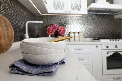 Photo of Beautiful ceramic dishware on countertop in modern kitchen