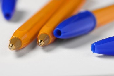 Photo of Ballpoint pens on white background, closeup view