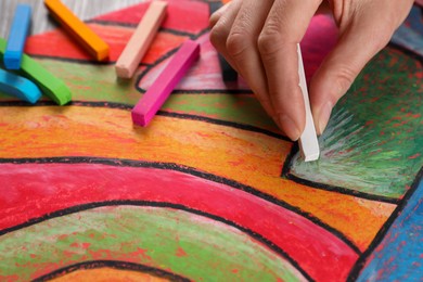 Photo of Woman drawing abstract picture with soft pastel, closeup