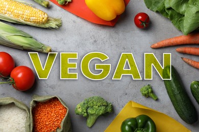 Image of Word Vegan and fresh products on light grey background, flat lay