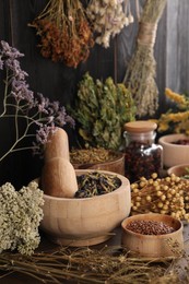 Photo of Many different dry herbs and flowers on table