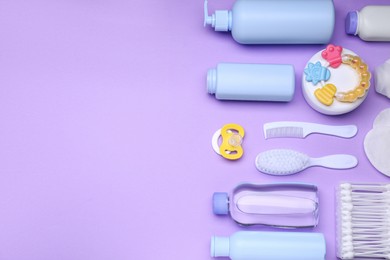 Photo of Flat lay composition with baby care products and accessories on lilac background, space for text