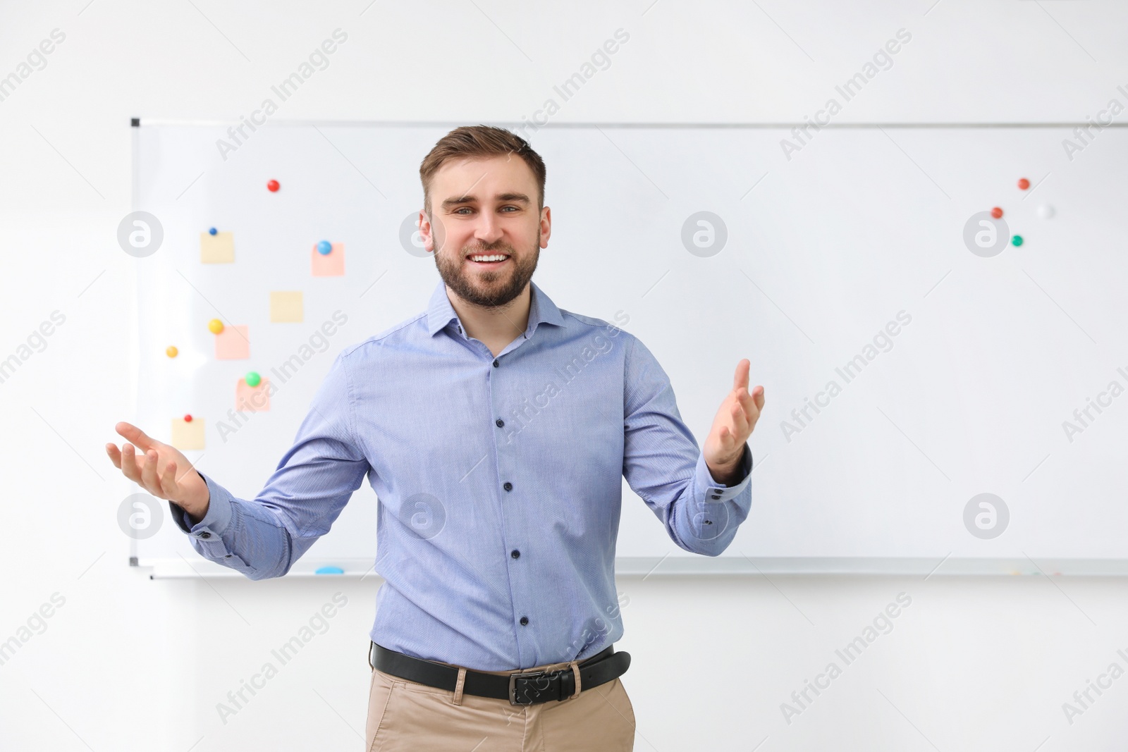 Photo of Portrait of young teacher near whiteboard in classroom