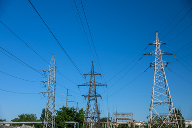 Modern high voltage towers against blue sky