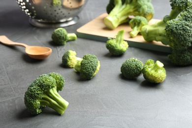 Photo of Fresh green broccoli florets on grey table