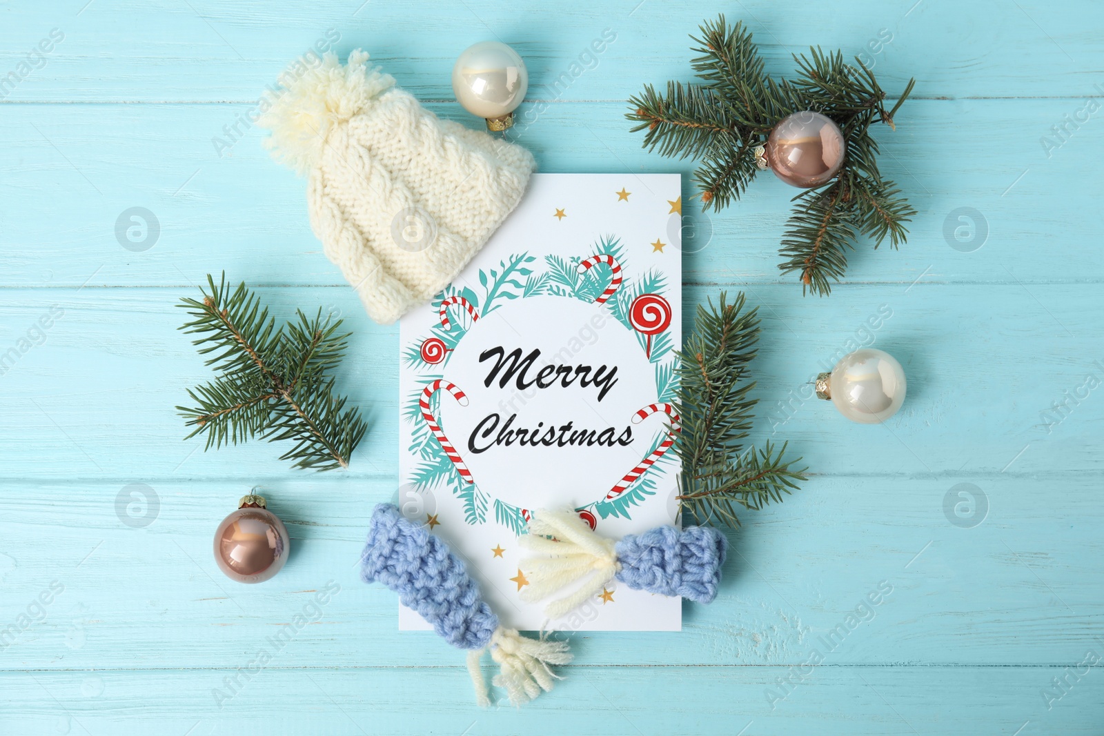 Photo of Flat lay composition with Christmas card and festive decor on light blue wooden background