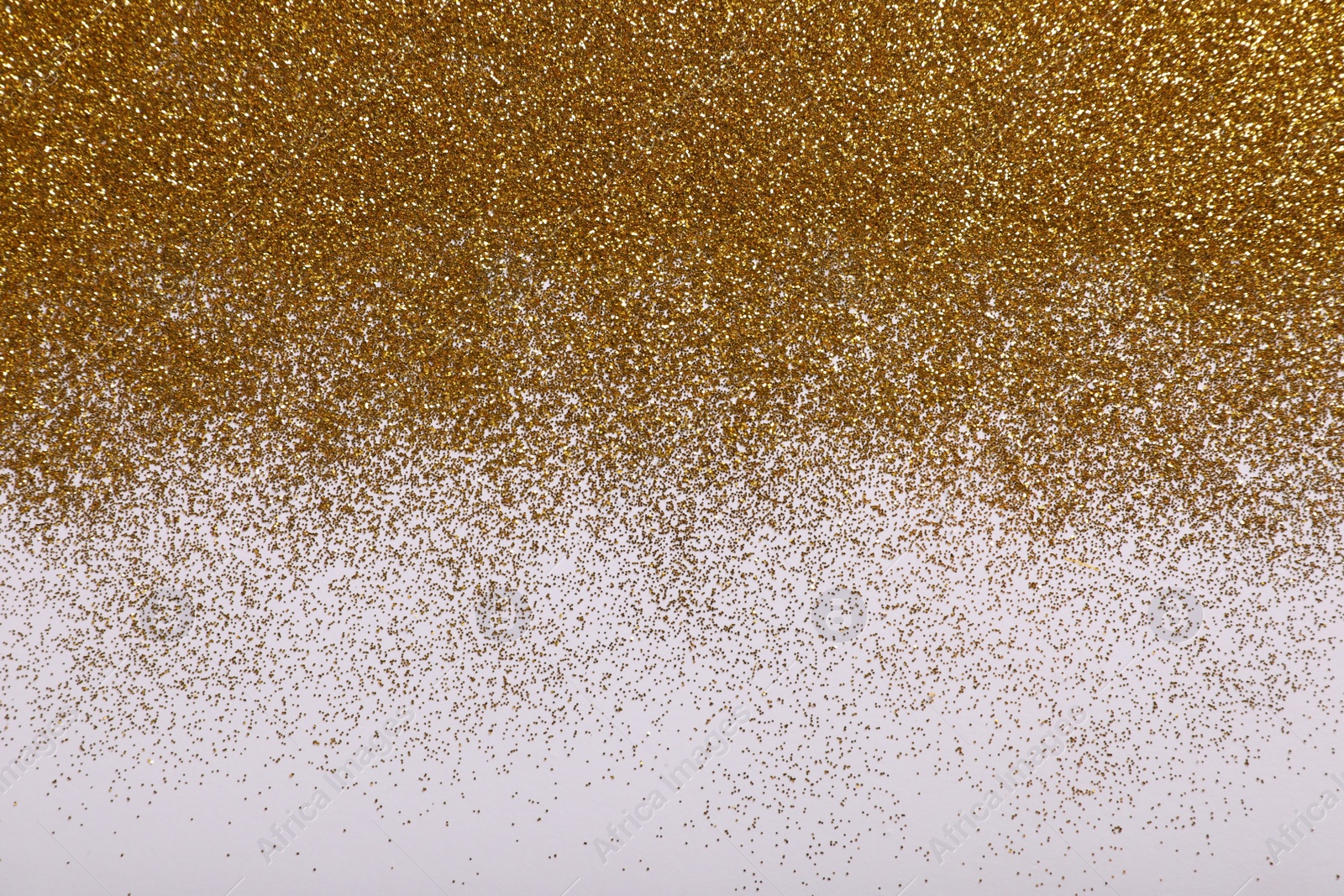 Photo of Shiny golden glitter on white background, top view