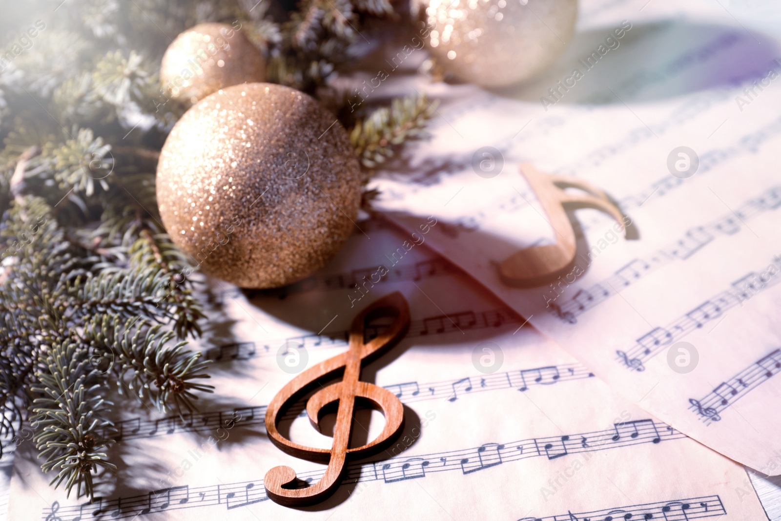 Image of Composition with Christmas balls and wooden music notes on table