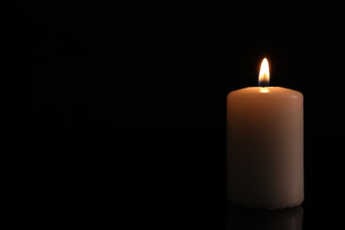 Photo of Burning candle on dark background, space for text. Memory day