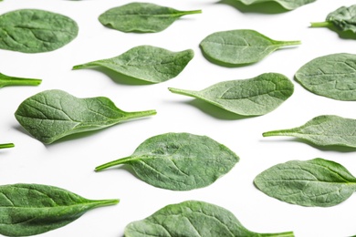 Fresh green healthy spinach leaves on white background