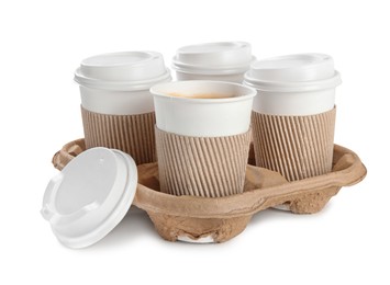 Photo of Takeaway paper coffee cups with sleeves in cardboard holder on white background