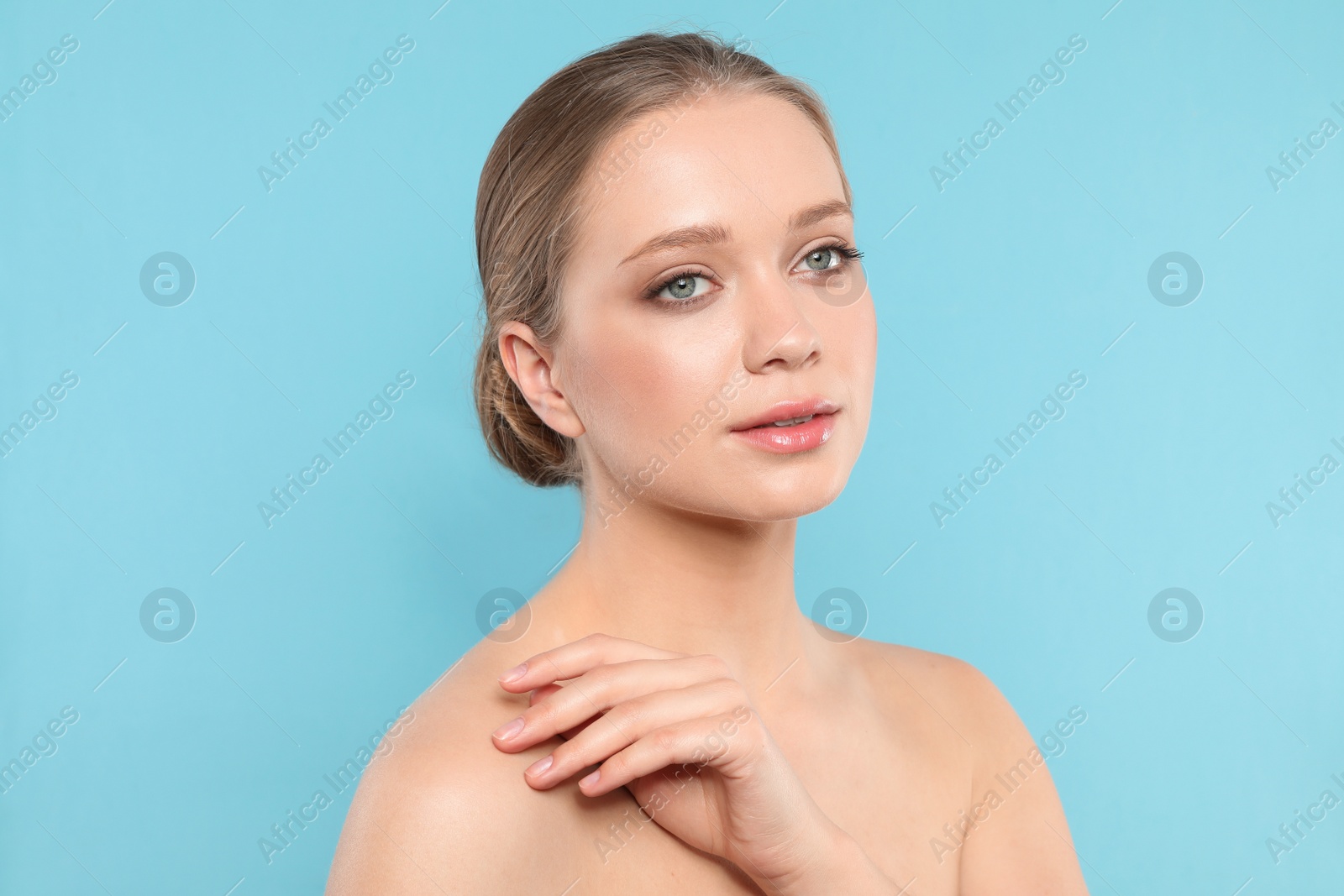 Photo of Portrait of young woman with beautiful face on blue background