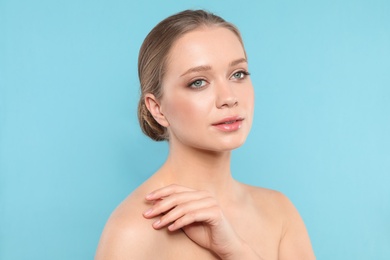 Photo of Portrait of young woman with beautiful face on blue background