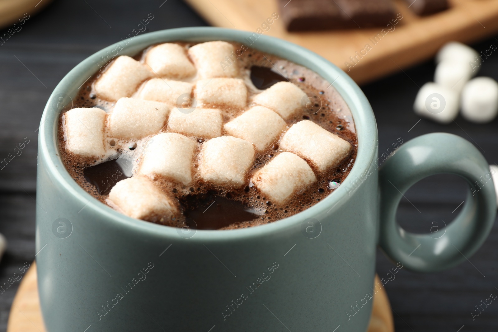 Photo of Cup of aromatic hot chocolate with marshmallows on table, closeup