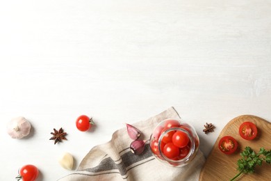 Photo of Pickling jar with fresh ripe cherry tomatoes and spices on white wooden table, flat lay. Space for text