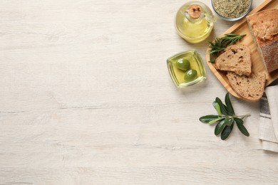 Photo of Flat lay composition with olive oil on wooden table, flat lay. Space for text