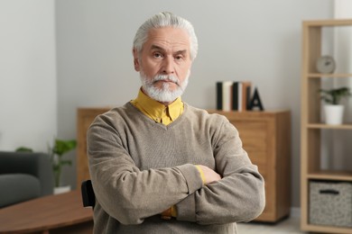 Photo of Portrait of handsome senior man at home