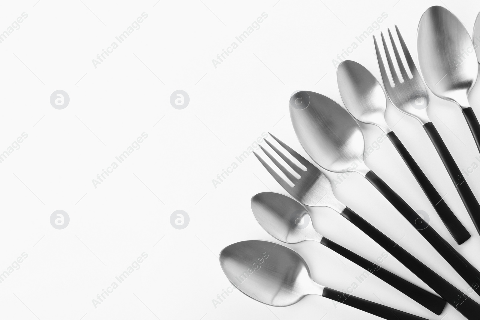 Photo of Forks and spoons on white background. New cutlery