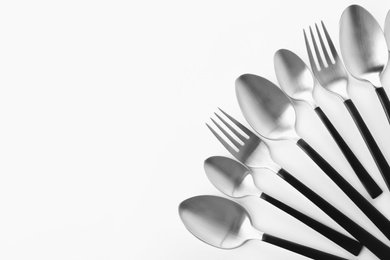 Photo of Forks and spoons on white background. New cutlery