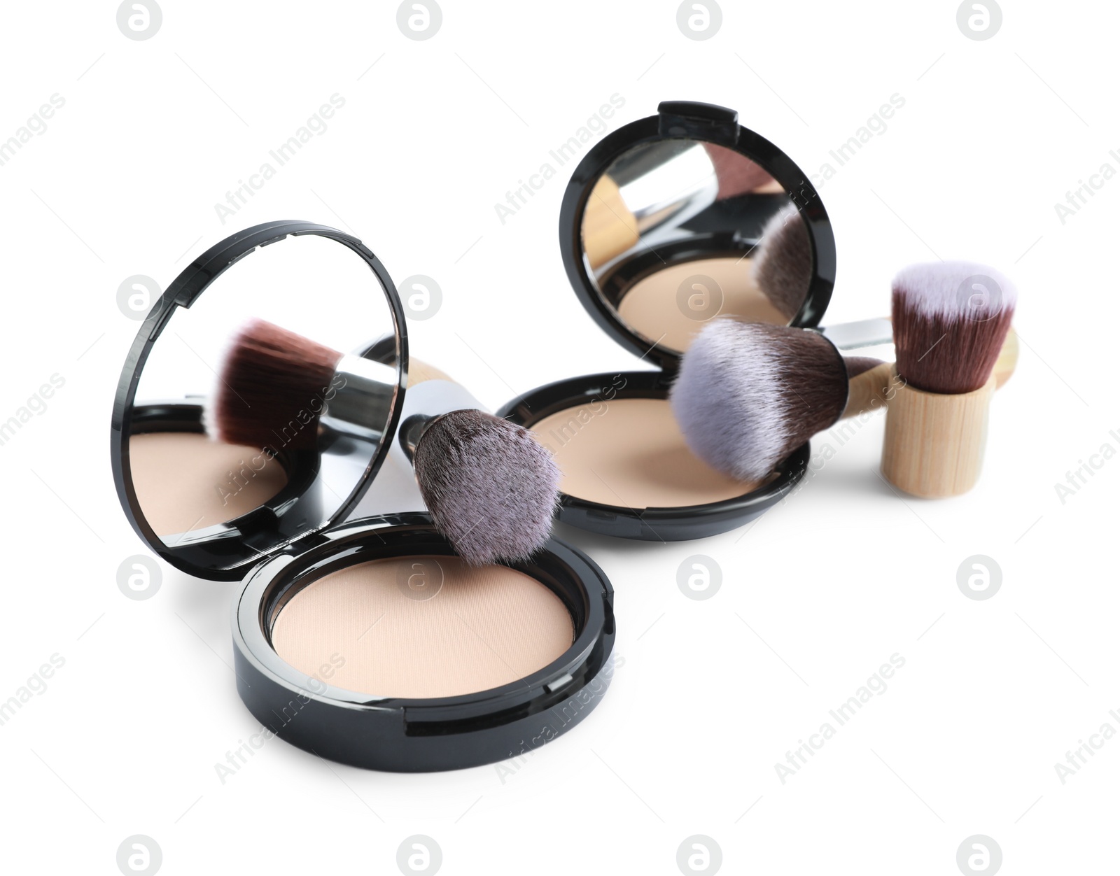 Photo of Face powders and brushes isolated on white