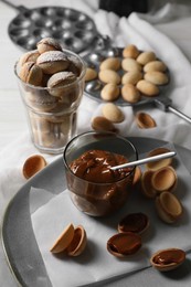 Delicious walnut shaped cookies with condensed milk on table, above view