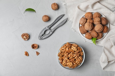 Flat lay composition with walnuts on grey background