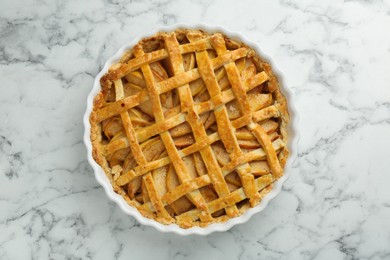 Photo of Tasty homemade quince pie on white marble table, top view