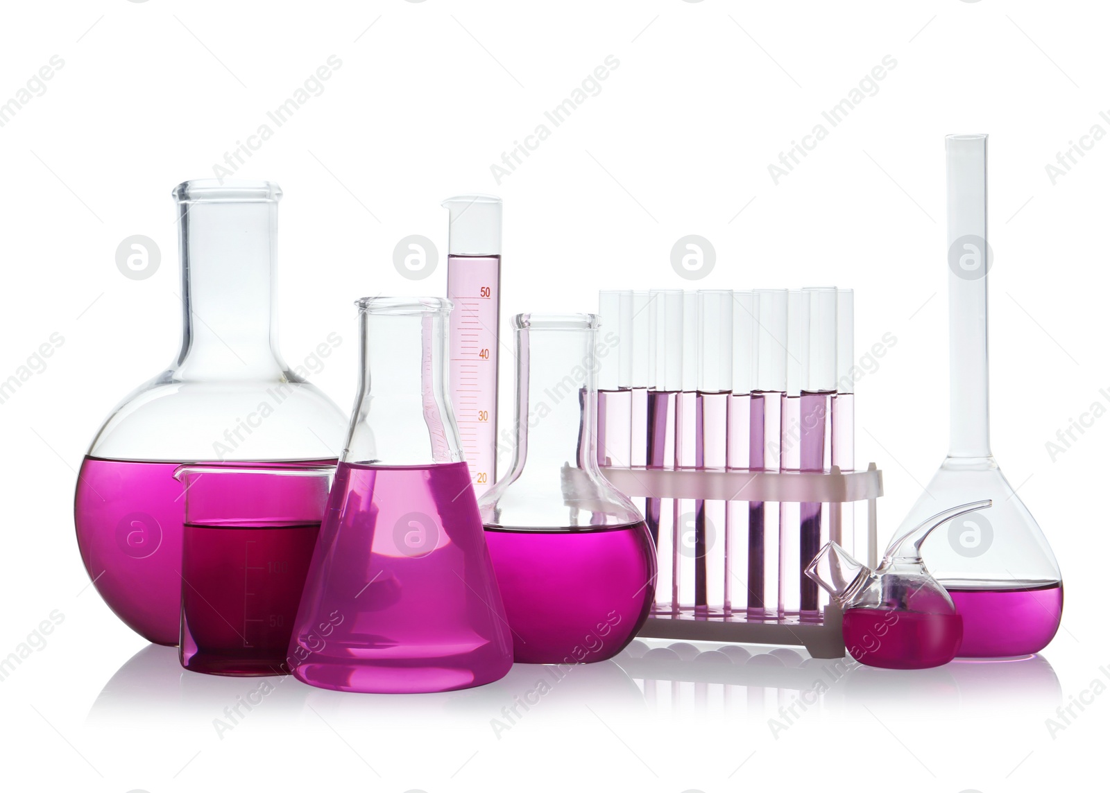 Photo of Laboratory glassware with purple liquid on white background